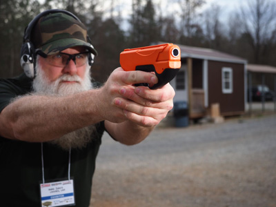 A bearded man holding the Prepared2Protect P2P HDP50 Compact in the ready postition.